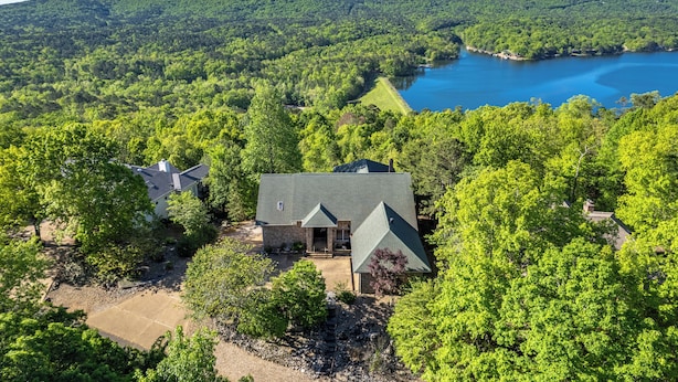 An aerial view of a house surrounded by dense forest and a lake. - Lake View Home with Game Room - Pet Friendly - Spacious Home (Hot Springs)