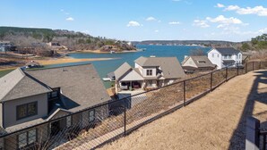 A residential area with houses, a dock, and a body of water. - Mallard Pointe 100 - Luxury condo- conveniently located! (Cullman)
