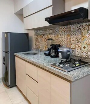 A kitchen with a refrigerator, stove, and countertop. - Live the best vacations in Cali, Colombia! (Cali)