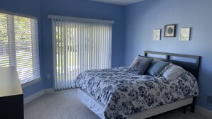 A bedroom with a bed, a window with blinds, and a ceiling light. - The Spacious Canal Condo (Caseville)