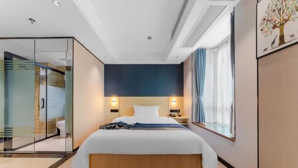 A modern hotel room with a large bed, bedside lamps, a glass partition, and a view of the outdoors. - Xiangju Business Hotel (Qingyuan Gulongxia Meilin Plaza) (Qingyuan)