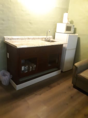 Fridge, microwave, paper towels, dining tables