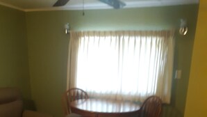 A dining area with a round table and chairs, a sofa, and a small table. - Magnolia Gallery & Inn - lodging in an 1864 building in a living  ghost  town. (Austin)