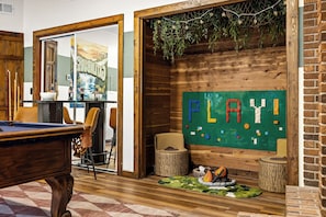 A pool table, chairs, a LEGO play area, and a cozy seating area with a fireplace. - LUXE Cabin * Stunning Views * Heated Pool * Sauna * Hot Tub * Location (Gatlinburg)