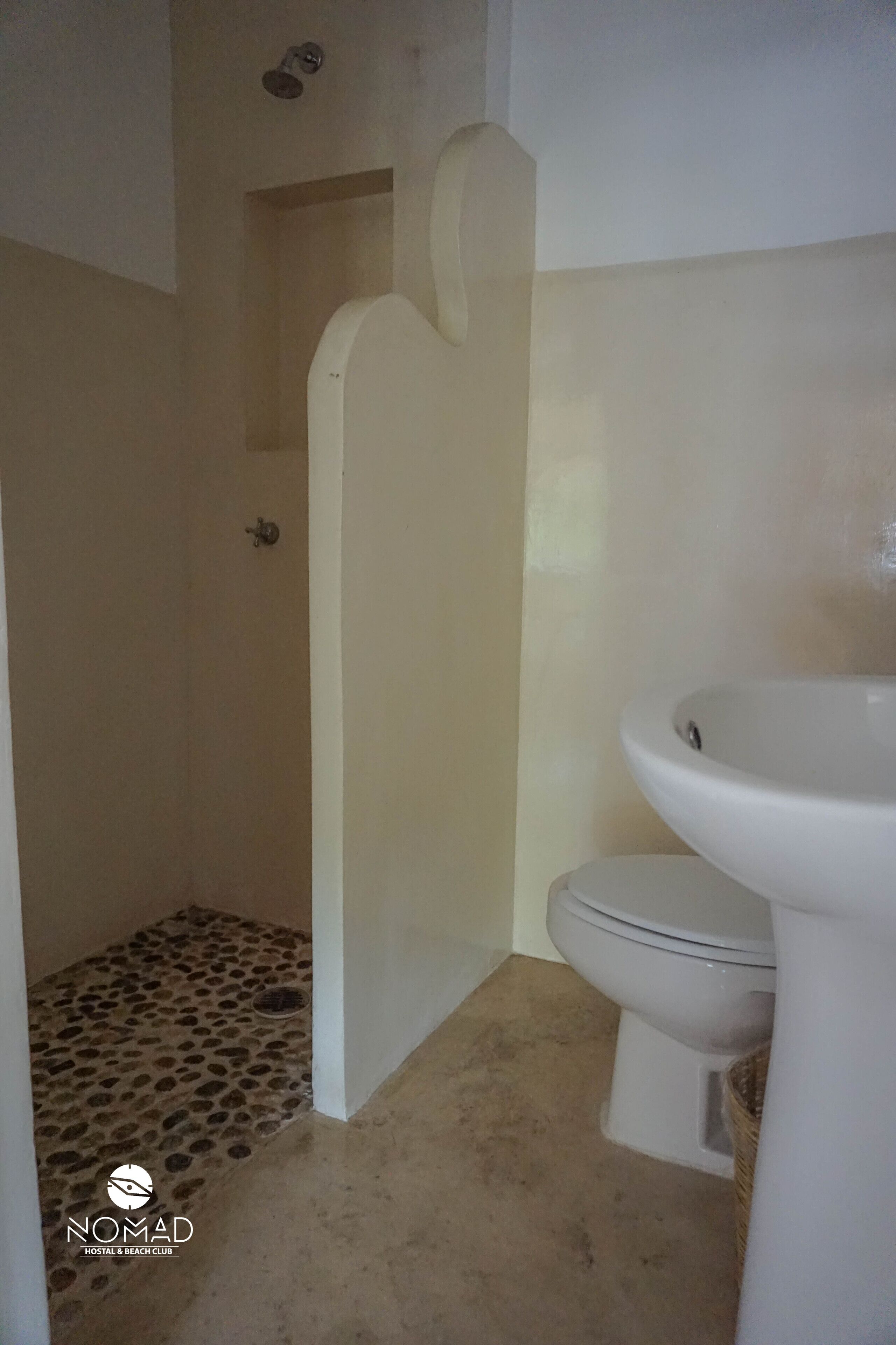 A bathroom with a toilet, sink, and shower.
