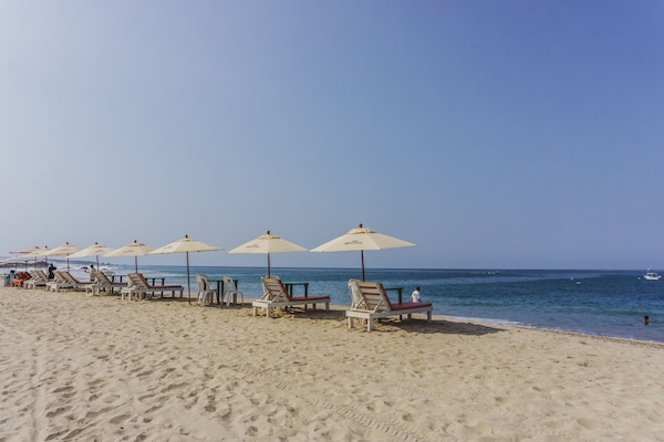 On the beach, white sand, beach umbrellas, beach towels