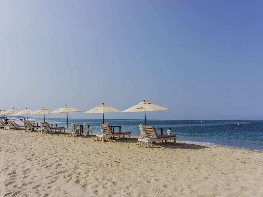 On the beach, white sand, beach umbrellas, beach towels