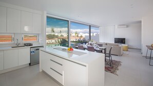 A modern kitchen with a large island, a dining area with a view, and a living room with a TV. - The Ultimate 5 Star Holiday Villa in Protaras with Private Pool and Close to the Beach (Protaras)