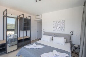 Una camera da letto con un letto, un armadio, un comodino e un quadro appeso al muro.