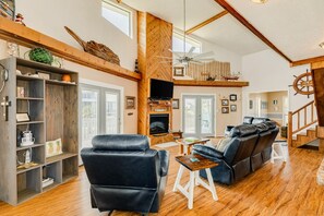 Cozy living area with a fireplace, comfortable seating, and a TV for entertainment.