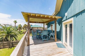 Relax in a shaded outdoor space with comfortable seating and a view of the surrounding neighborhood.