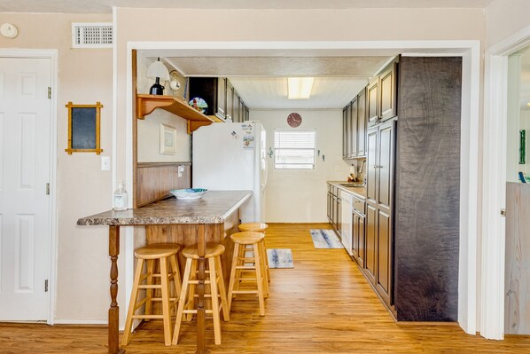 Enjoy casual dining or working at the central island with three stools.