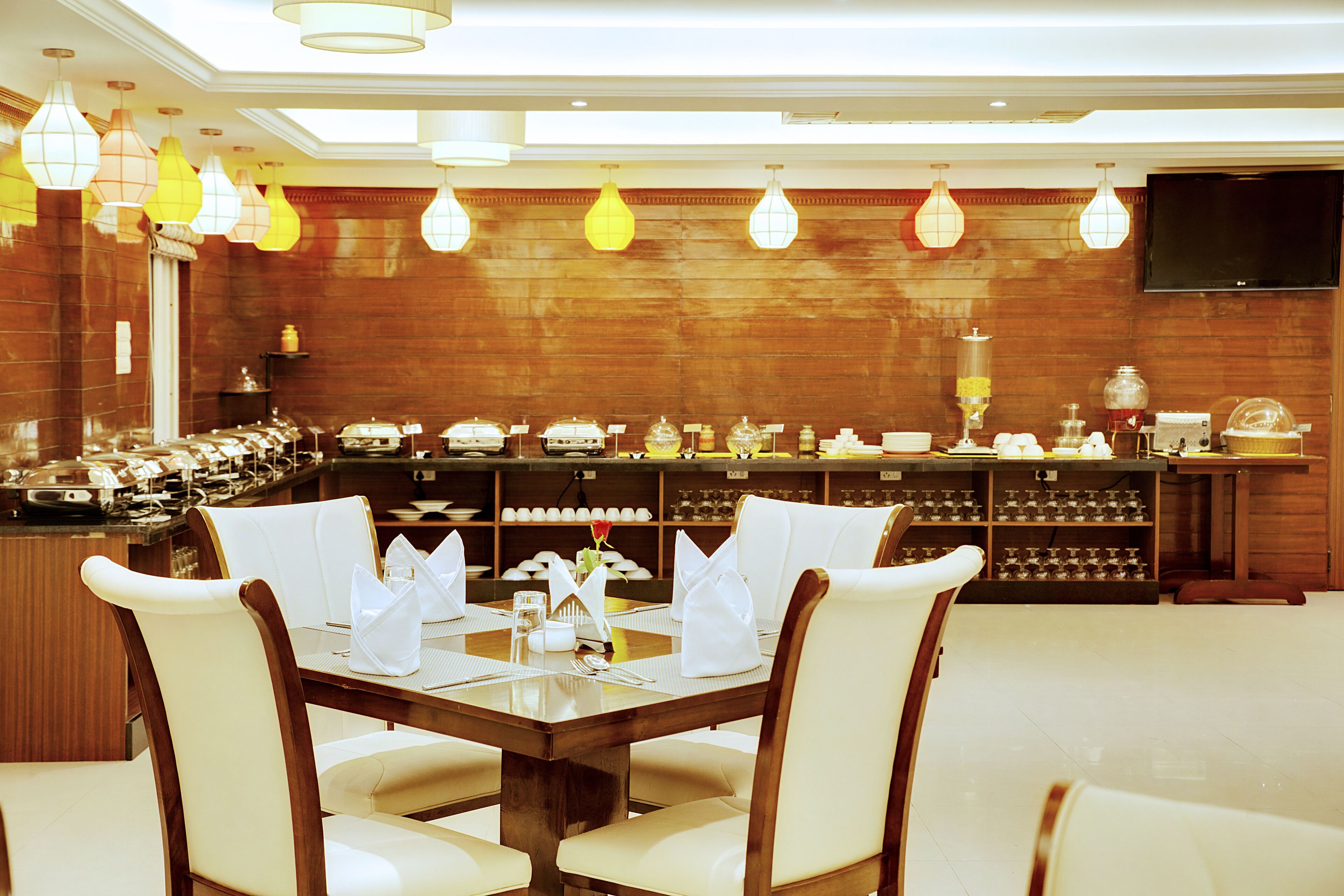 A restaurant with a buffet setup, including a variety of food items and a seating area with tables and chairs.