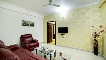 Suite, 1 King Bed, City View | Living area | 32-inch LED TV with satellite channels, TV