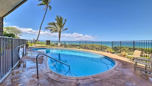 A circular pool with a metal railing, surrounded by a concrete deck and a black metal fence. - Gorgeous Oceanfront Kihei Condo w/ Balcony! (Kihei)