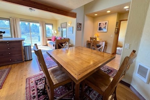 Enjoy meals in this dining area with a large table and six chairs, surrounded by natural light and beautiful views.