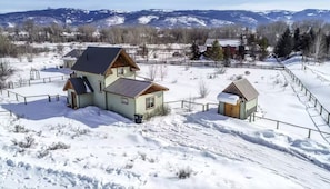 Escape to a serene winter wonderland surrounded by rolling hills and rustic charm.