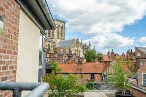 Stunning cathedral with Gothic architecture, surrounded by traditional brick buildings and red-tiled roofs.