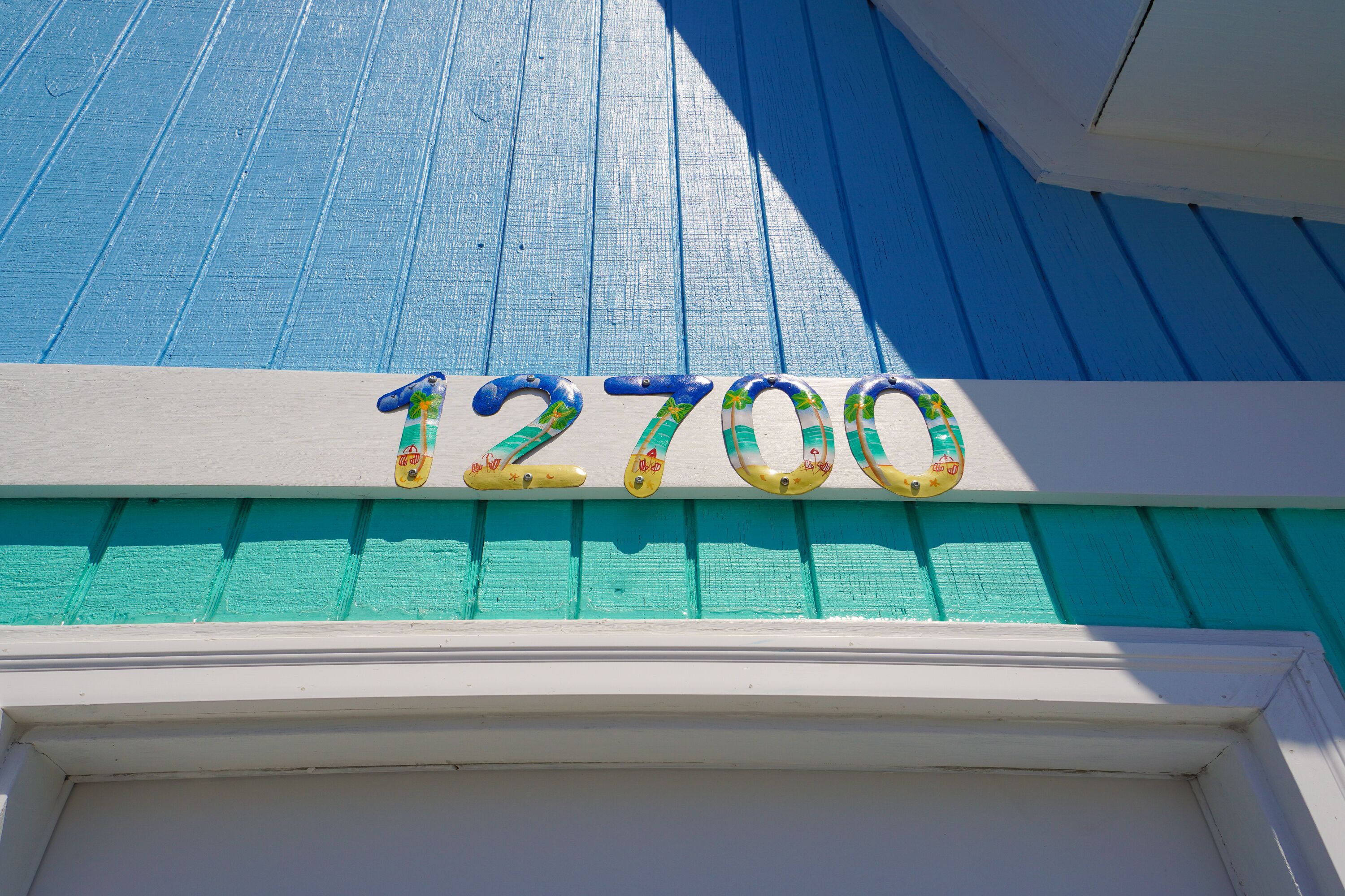 A building with a blue exterior and a white door.
