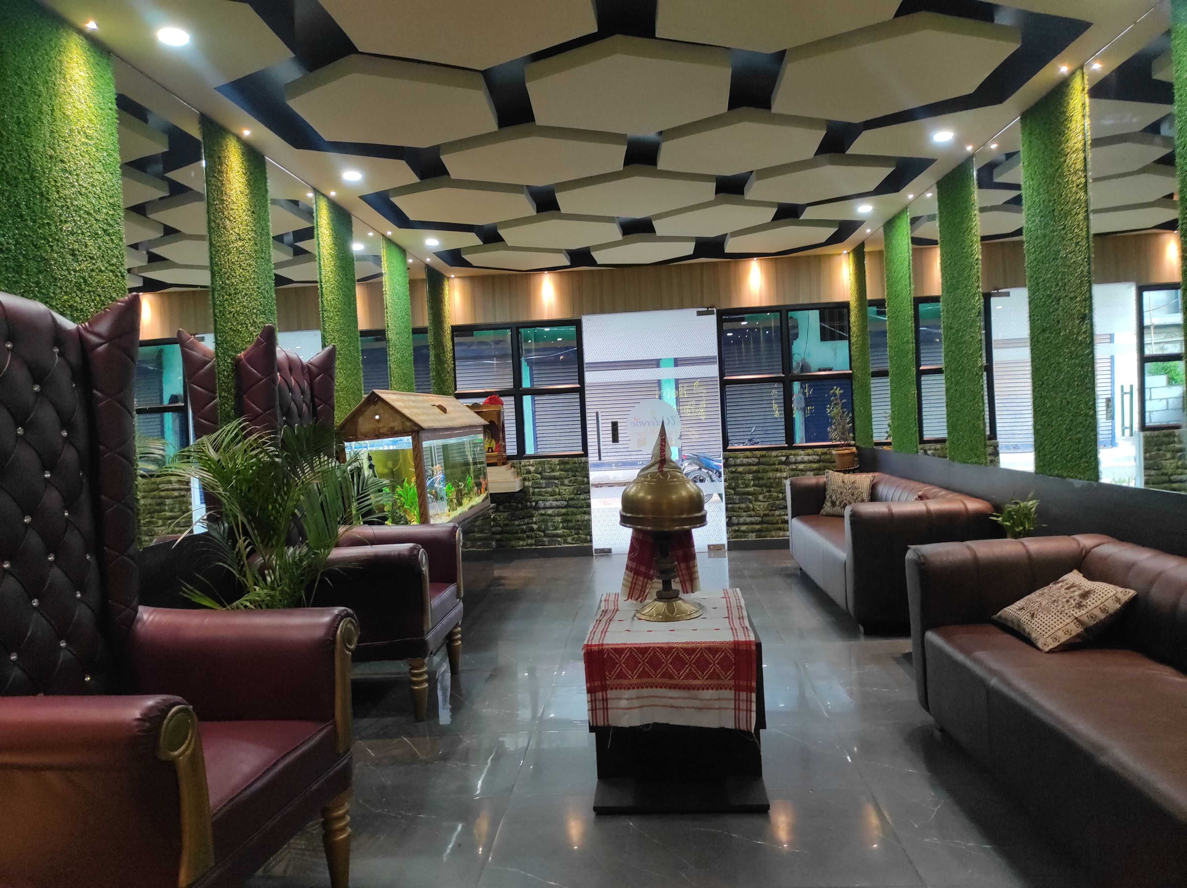 A lobby with leather sofas, a coffee table, and a fish tank.