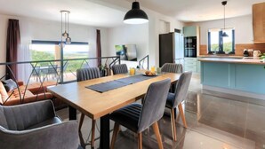A modern kitchen with a dining area, large windows, and a view of the outdoors. - Villa Bella by Interhome (Novigrad (Istra))