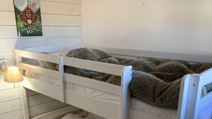 A bunk bed with a lamp on the nightstand, a wooden floor, and a wall-mounted picture. - Rental Apartment 2 room 26 M2 - Alps - Avoriaz - Douchka - Falaise (Morzine)