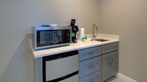 A compact kitchen with a microwave, coffee maker, and sink. - HS#1- Modern Studio next to Premier Sports Complex (Bradenton)