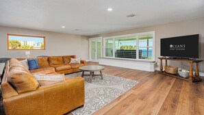 A living room with a sofa, a coffee table, and a television.