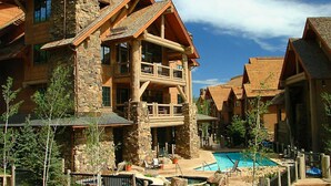 A resort with multiple buildings, a central pool, and outdoor seating areas. - Gorgeous 4 bedroom ski-in/out condominium, immaculate interior!! (Bachelor Gulch)