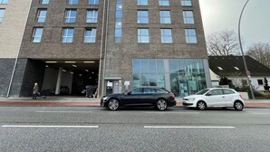 A multi-story building with a modern architectural design, featuring a mix of brick and glass facades.