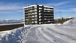 A multi-story building with balconies, situated on a snowy slope with a clear sky. - 300m from resort center, 3rd floor, terrace, balcony, tv, 29m², Chamrousse (Chamrousse)