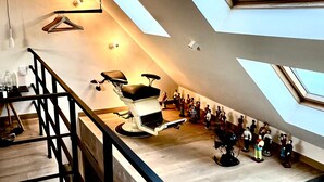 A spacious room with skylights, a seating area with chairs, and a staircase. - Agelandkaai.be (Ghent)
