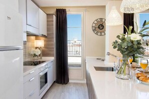 Een moderne keuken met een inbouwoven, een spoelbak en een ontbijt klaar gezet aan een eettafel.