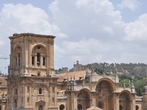 A historic building with a prominent bell tower and arches.