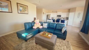 A modern living room with a sectional sofa, a bear plush toy, and a coffee table. - Modern 3 BD House in Cottonwood Downtown, 20 mins to Sedona.  (Cottonwood)