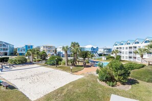 A beachfront hotel with multiple-story buildings, a sandy beach area, and a pool. - Ocean View Beachfront +In/Outdoor Pools + Sauna! (Gulf Shores)