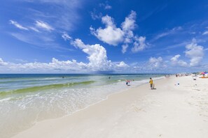 Guests can enjoy a serene beach experience with gentle waves lapping at the shore.