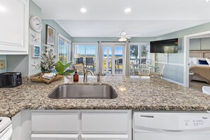 Enjoy ocean views from the large window and balcony with outdoor seating.