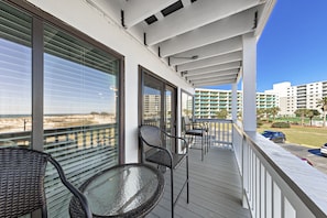 Enjoy the ocean view from this balcony with a comfortable seating area.