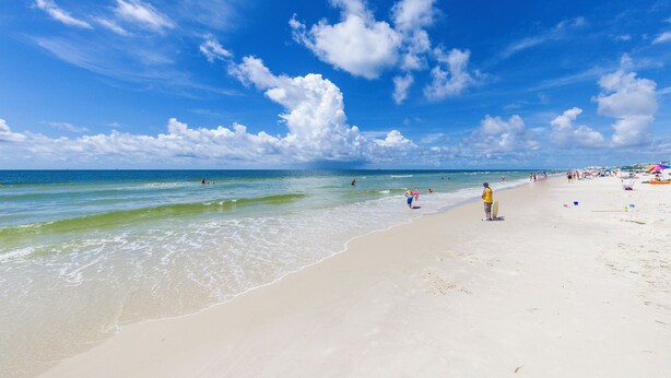 A beach with clear skies and calm waters.