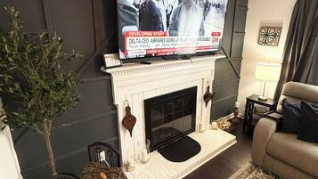 TV connectée, cheminée, chaîne hi-fi, écrans d'ordinateur