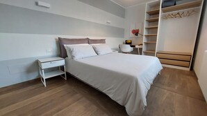 A neatly arranged bedroom with a bed, bedside table, and a wardrobe. - Fantastic farmhouse with swimming pool just a step away from Cinque Terre. (Sesta Godano)