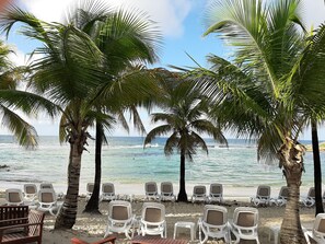 On the beach, white sand, sun-loungers, beach umbrellas