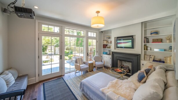 A spacious living room with a large bed, seating area, and a fireplace. - Spacious 3BR Historic Home | Walk Downtown+Parking (Kennett Square)