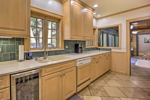 Enjoy cooking in this well-equipped kitchen with a large island, dishwasher, and window with a view.