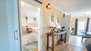 A cozy room with bunk beds, a wooden console table, and a desk with a lamp. - Ground Level, Bayside Retreat w/ bay access! Dogs OK, Large Pond (Eastpoint)