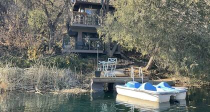 Unique treehouse on large private pond with your own private pier. TOO COOL!