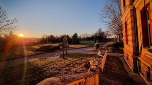 A building with a brick facade and a pathway leading to a grassy area. - Charming house in a 7-hectare listed property (MONTLAUR)