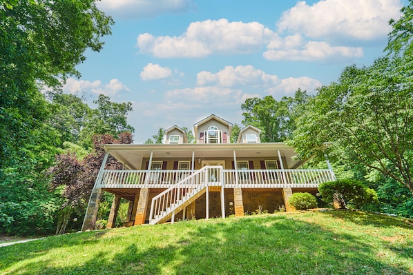 A two-story house with a covered porch and a staircase leading to the upper level. - Golfer’s Smoky Mountain Retreat! (Newport)
