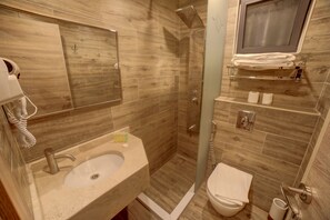 A bathroom with a sink, toilet, and shower area. - Alena Hotel (Aqaba)